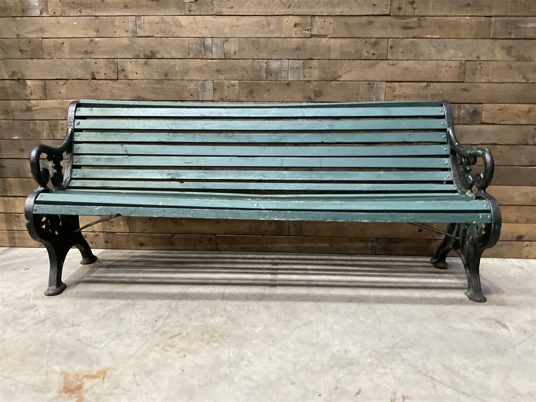 Early 20th century slatted garden bench with scrolling cast iron bench ends
