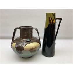 T. Forester Phoenix ware ewer of tapering form decorated with peacock and Bretby twin handled vase decorated with figures fishing in a boat sea scene