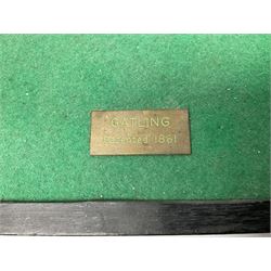 Scratch built brass model of an 1861 Gatling Gun with rotating barrels, hinged cover revealing mechanism, on metal bound wooden spoked wheels and rectangular base L47cm H22cm