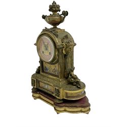 French - late 19th century 8-day clock set, gilt metal case with inset painted panels, leaf work and surmounted by an urn, case raised on a wooden padded base, with two associated Greek style urns mounted on a stepped alabaster plinth, painted dial with gilt numerals and hands, two train rack striking movement, striking the hours on a  bell. No pendulum or key.