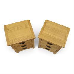 Pair of solid light oak bedside chests, rectangular top over three graduating drawers with metal handles and plates, on square feet