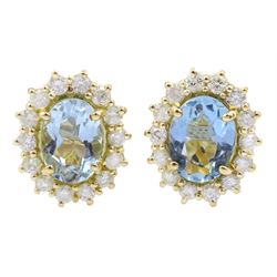 Pair of 18ct gold oval aquamarine and diamond cluster stud earrings, hallmarked, total aquamarine weight approx 1.65 carat, total diamond weight approx 0.55 carat