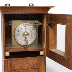 John Whitehurst of Derby- late 19th century oak cased wall hanging Noctuary or night watchman's wall clock, in a rectangular case with a moulded and glazed door to the dial and full length trunk door, with a silvered circular dial and a brass indicating pointer, Arabic numerals and quarter hour track with steel time recording pins, four wheel chain driven going train. No pendulum,chain or weight.    
John Whitehurst is one of the most prolific makers of these distinctive early type of night watchman's clocks, used predominantly in industrial premises, factories and mills in the north west of England during the 19th century.