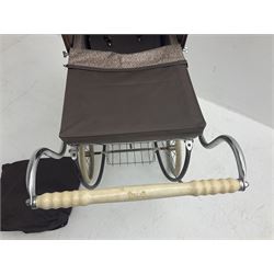 Pair of 1980s Silver Cross brown coach built dolls prams; each with folding canopy and apron, tubular framework with suspension, spoked wheels with brake and luggage rack and separate matching shopping bag L93cm