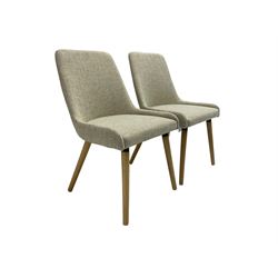Pair contemporary side chairs, upholstered in light grey fabric, on splayed supports