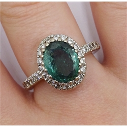 18ct gold oval green stone and diamond cluster ring, with diamond set shoulders by Lorique, hallmarked