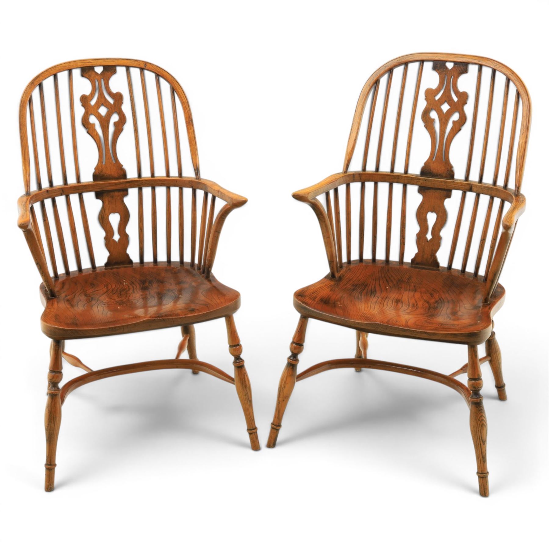 Pair of high back Windsor armchairs, fleur de lis back splat, dished seat, caroline stretcher