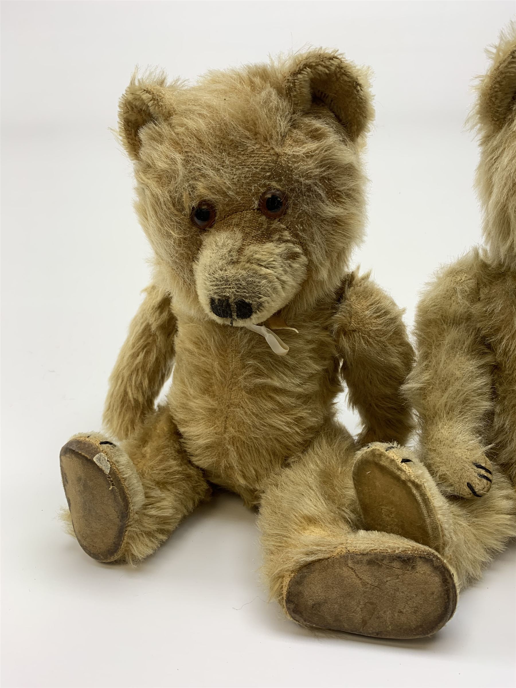 Chiltern Ting-a-Ling teddy bear c1950s with blond mohair body, swivel jointed head with glass eyes and vertically stitched nose and mouth, jointed limbs with velvet pads and card lined feet and internal chimes H14