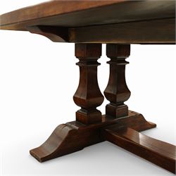 Country House 12' oak and fruitwood refectory dining table, the substantial rectangular plank top with cleated ends and chamfered edge, raised on twin trestle end square tapering and turned baluster supports with sledge feet and chamfered united by a long stretcher rail