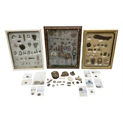 Collection of metal detecting finds, most contained within display frames and labelled, some loose, to include musket balls, bill hook, axe fragment, hubcaps, shell cases, regimental badges, coins, etc. 