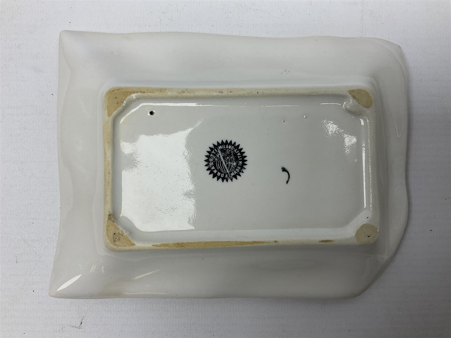 Two Fornasetti rectangular operatic posters ashtrays 'Norma' and 'Iris' decorated with black and white text with a gilt border edge, with printed mark beneath, H16cm