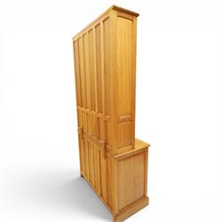 Knightman - oak dresser, the upper section fitted with twin glazed doors enclosing glass shelves, over open recess with panelled back, the base fitted with two drawers over twin panelled cupboards enclosing shelves, with recessed carved knight trademark, by Horace Knight of Old Mill Furniture, Balk near Thirsk