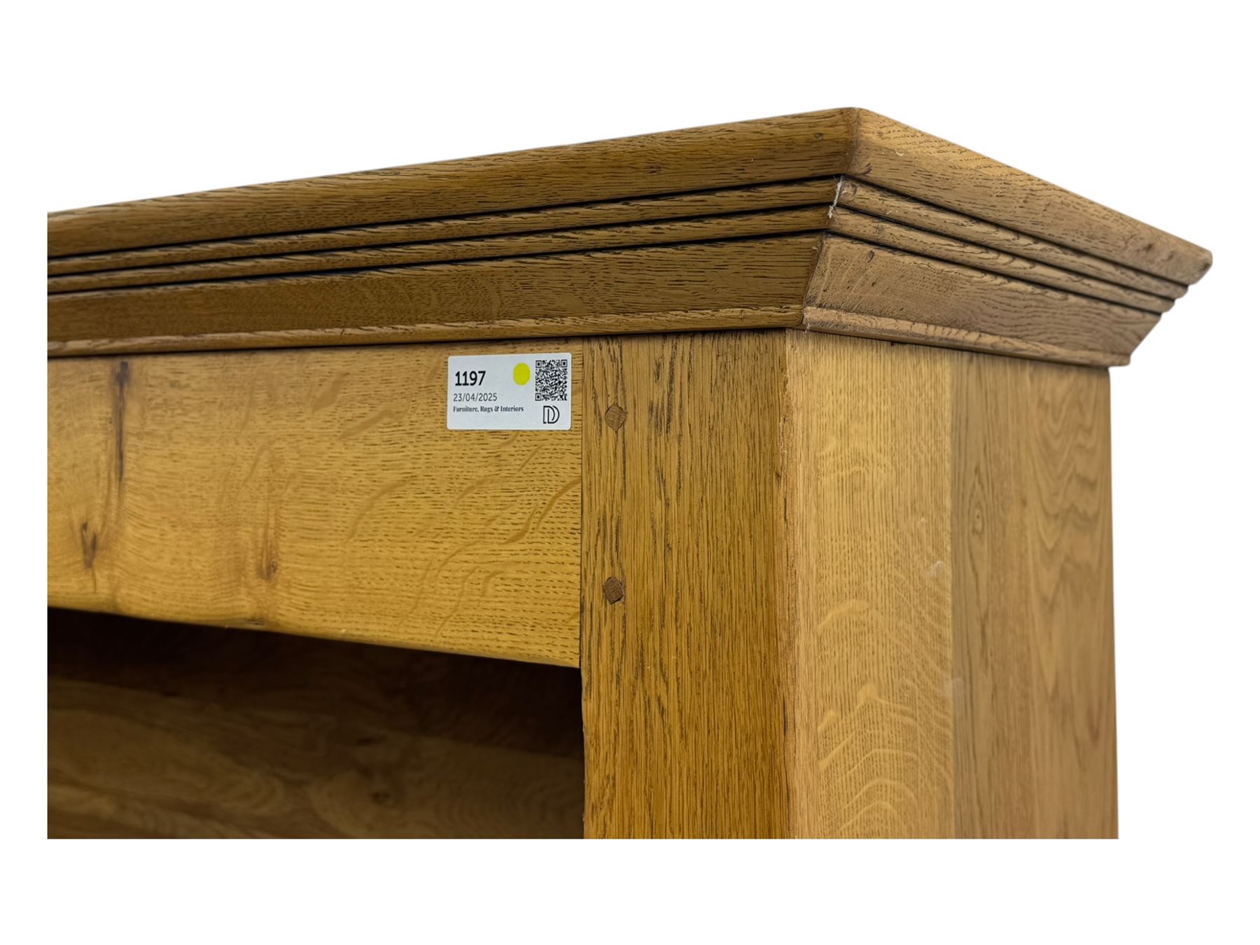 Contemporary French provincial design oak open bookcase, with projecting moulded cornice above a boarded back, fitted with four adjustable shelves, on bracketed plinth base