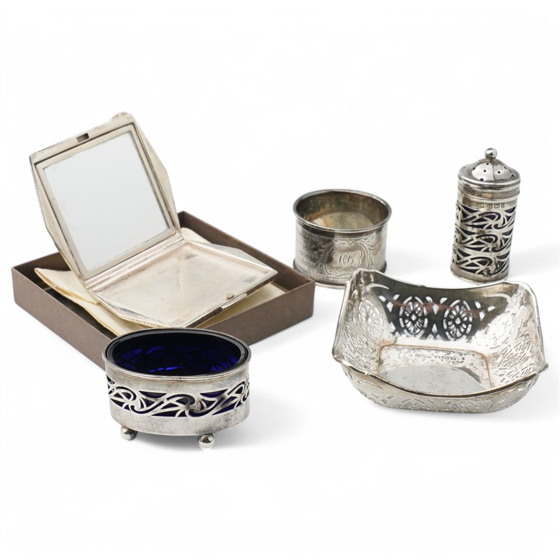 Engine turned silver powder compact Birmingham 1938, silver oval salt and matching pepperette Birmingham 1901, small silver sweetmeat dish and napkin ring