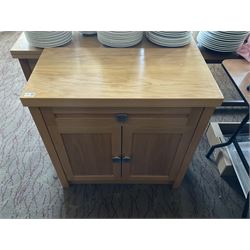 Light oak two door cabinet and a side table with two drawers- LOT SUBJECT TO VAT ON THE HAMMER PRICE - To be collected by appointment from The Ambassador Hotel, 36-38 Esplanade, Scarborough YO11 2AY. ALL GOODS MUST BE REMOVED BY WEDNESDAY 15TH JUNE.