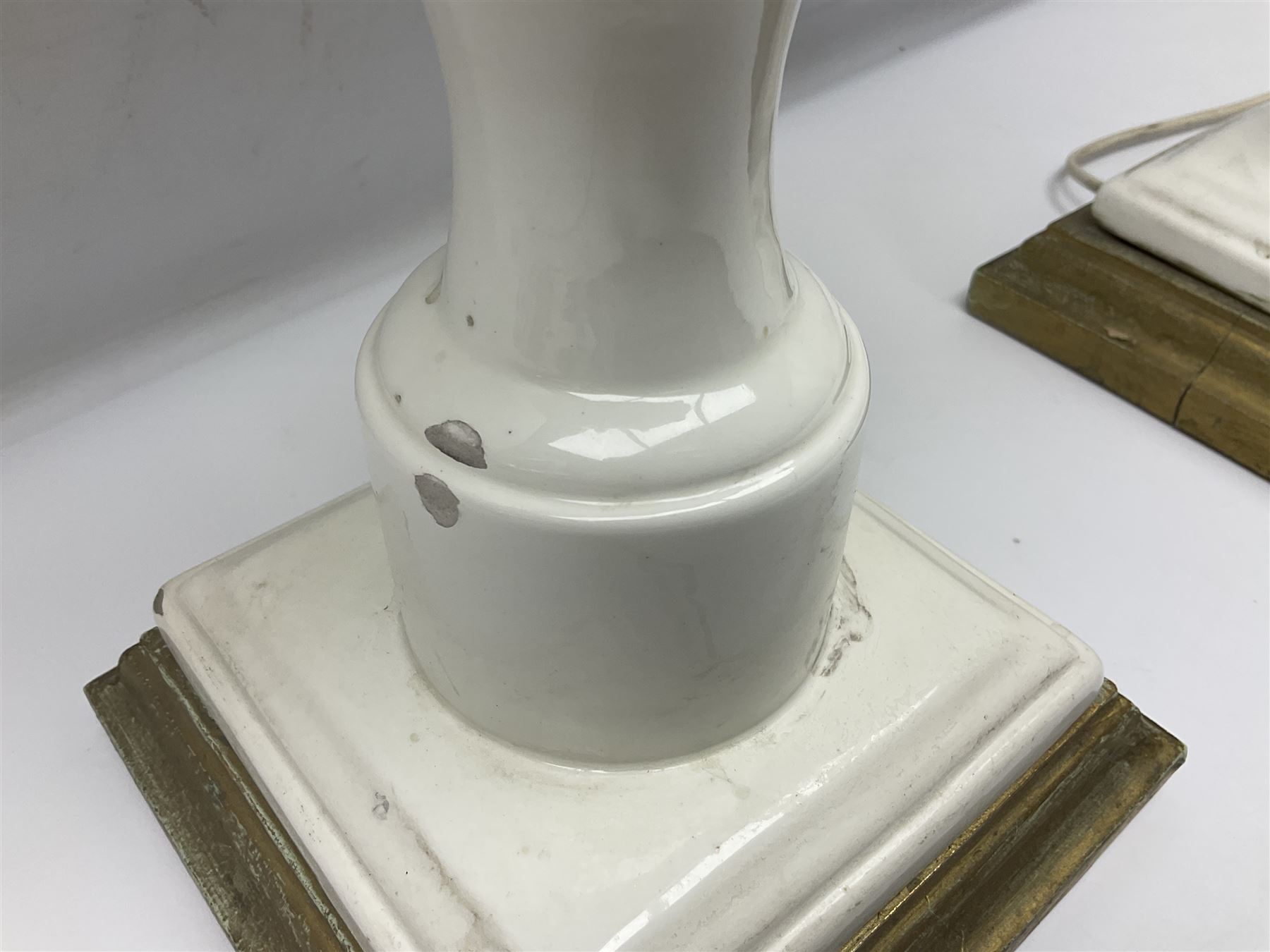 Pair of Casa Pupo white-glazed table lamps, modelled as a fruit upon a column of baluster form with foliate decoration, on a giltwood base, H62cm