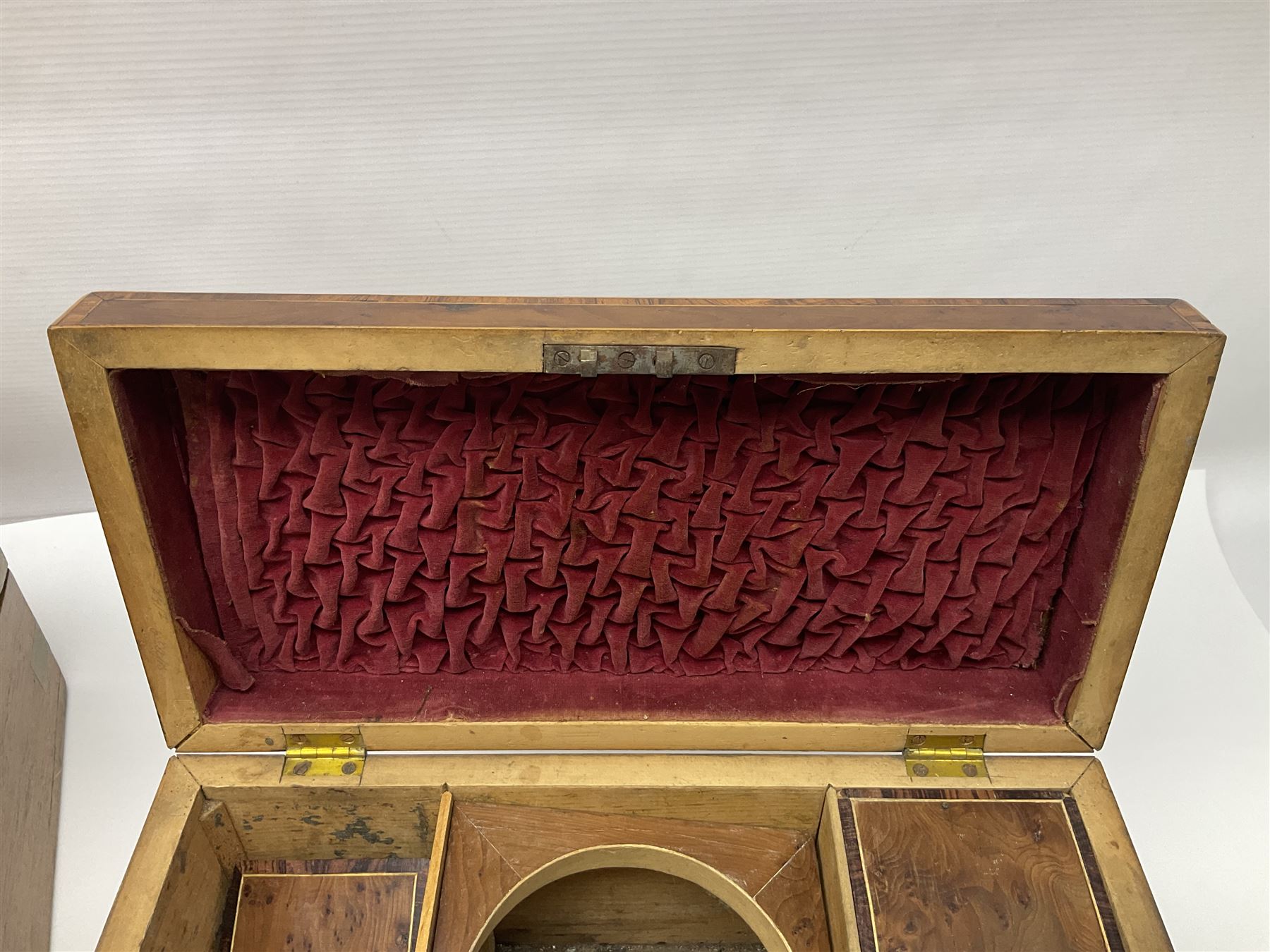 19th century burr yew wood tea caddy, of sarcophagus form, with strung details and brass mounts, the interior split into three compartments, upon four brass bun feet, together with an oak and brass bound writing slope, with red leather interior with gilt detailing, largest H16cm, W40cm