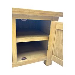 Contemporary oak television stand, rectangular top over two central open compartments, flanked by panelled cupboard doors enclosing additional shelves, raised on stile supports