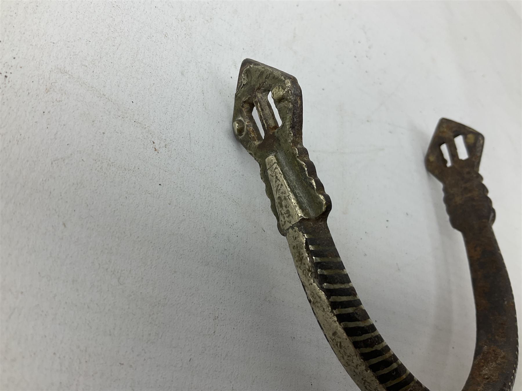 Pair of late 19th century South American iron spurs, engraved silver mounts, with sunburst rowls