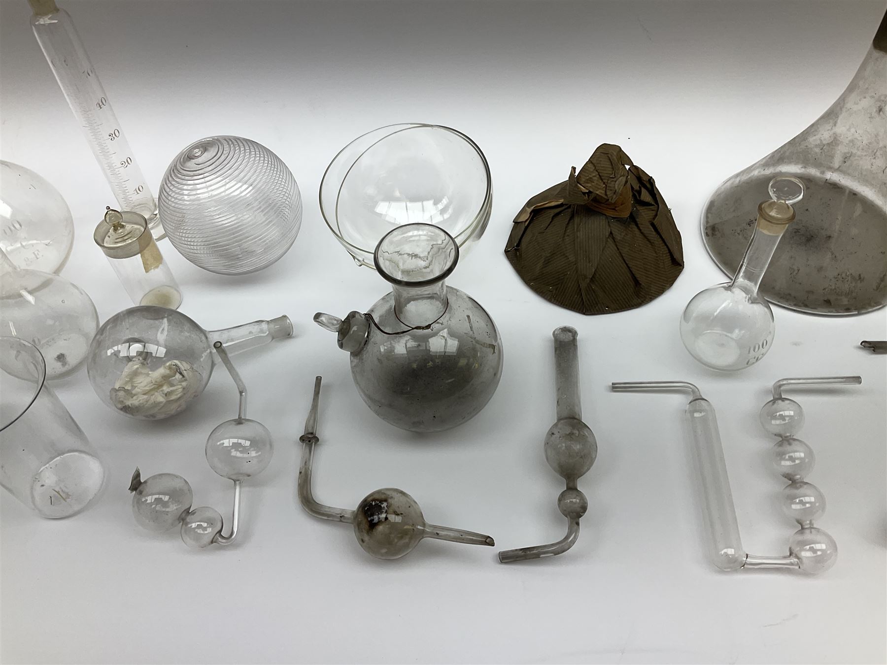Collection of 19th century and later pharmaceutical laboratory glass, to include, volumetric flasks of various sizes, conical flask, stratus flask, etc (25) Provenance: discovered in the storeroom of a long established Hull pharmacist and opticians