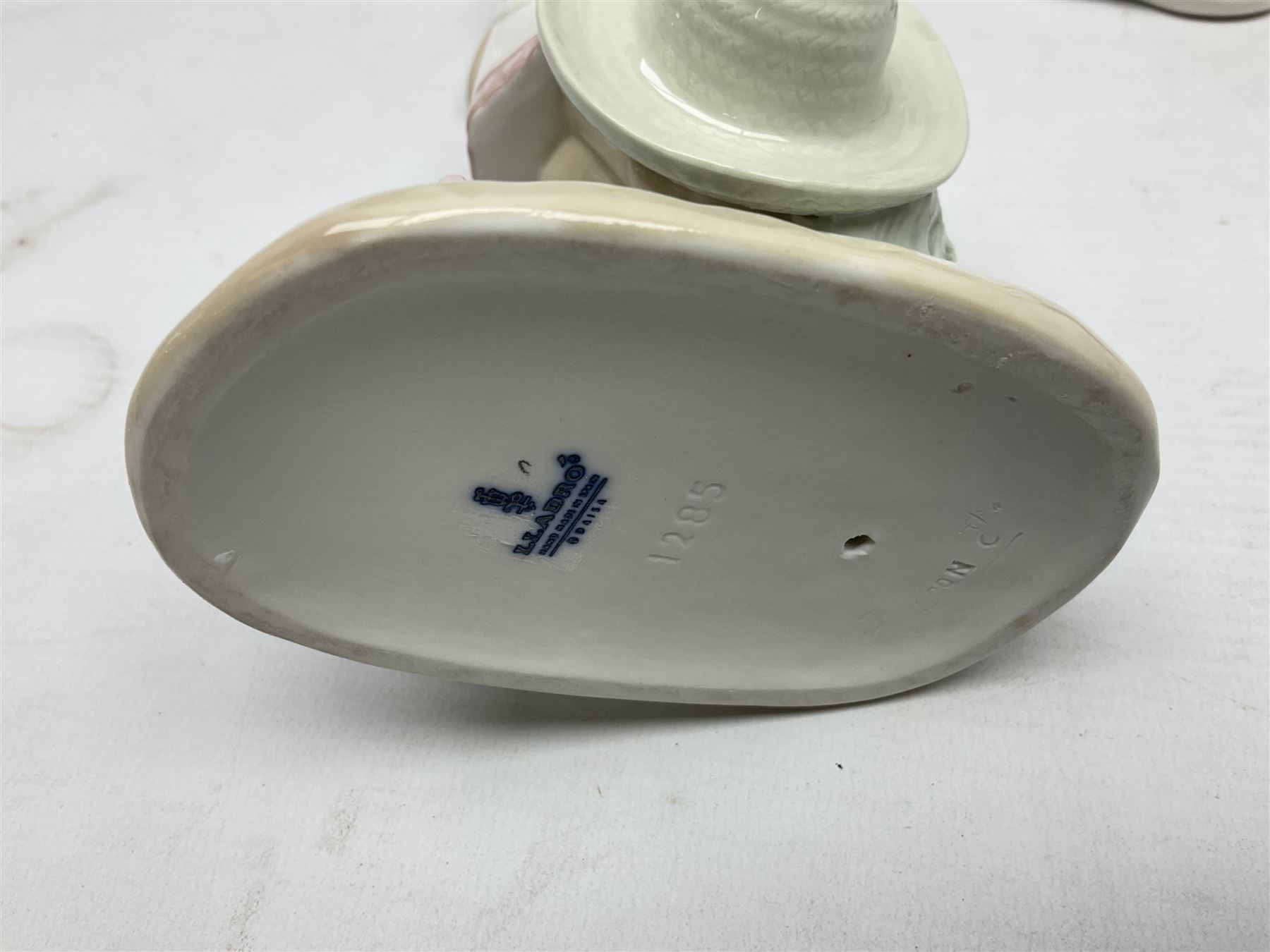 Three Lladro figures, comprising Modern Mother no 5873, Dropping the Flowers no 1285 and On the Beach no 1481, all with original boxes, largest example H30cm