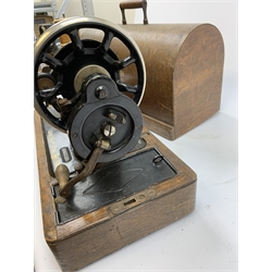 A cased vintage Singer hand crank sewing machine. 