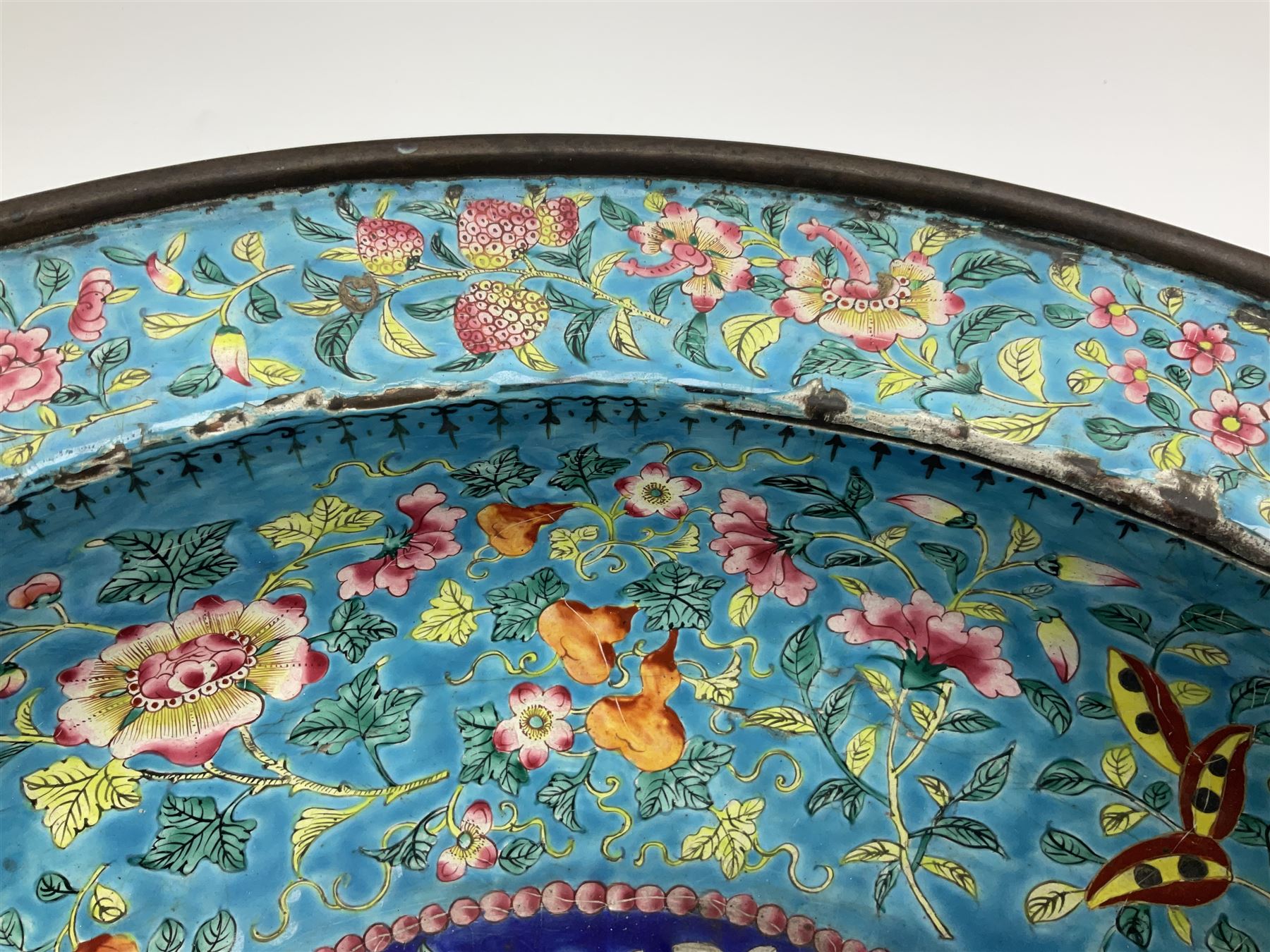 18th/19th century Chinese Canton enamel basin, the circular basin with flat everted rim, decorated with scrolling foliate and fruit decoration on a blue ground, D43cm