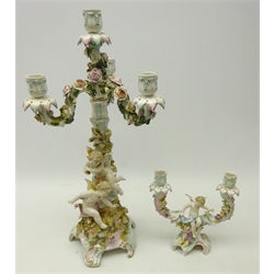  19th/ early 20th century Schierholz porcelain three branch candelabra with to winged cherubs and all over floral encrusted decoration, H51cm and another Schierholz twin branch candleabra with similar decoration (2)  
