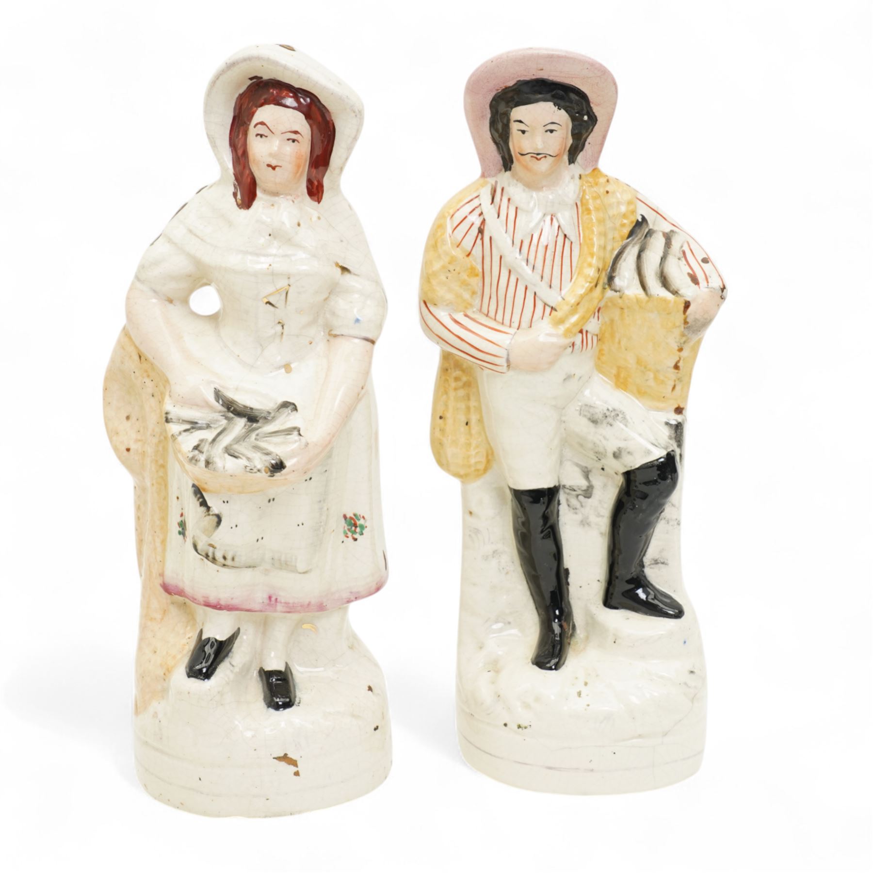 Staffordshire pottery figures including watch stand with piper and companion, pair of dogs and pups, pair of fish sellers and two others