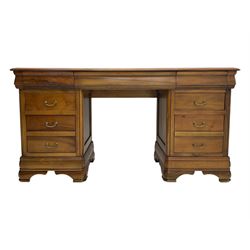 French cherry wood kneehole desk or dressing table, moulded rectangular top over twin pedestal bases each housing three drawers with brass-effect swing handles, resting on bracket feet
