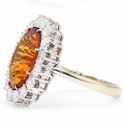 18ct white gold citrine and diamond cluster ring, single oval cut citrine of approx 4.30 carat, surrounded by sixteen round cut diamonds, total diamond weight approx 0.95 carat