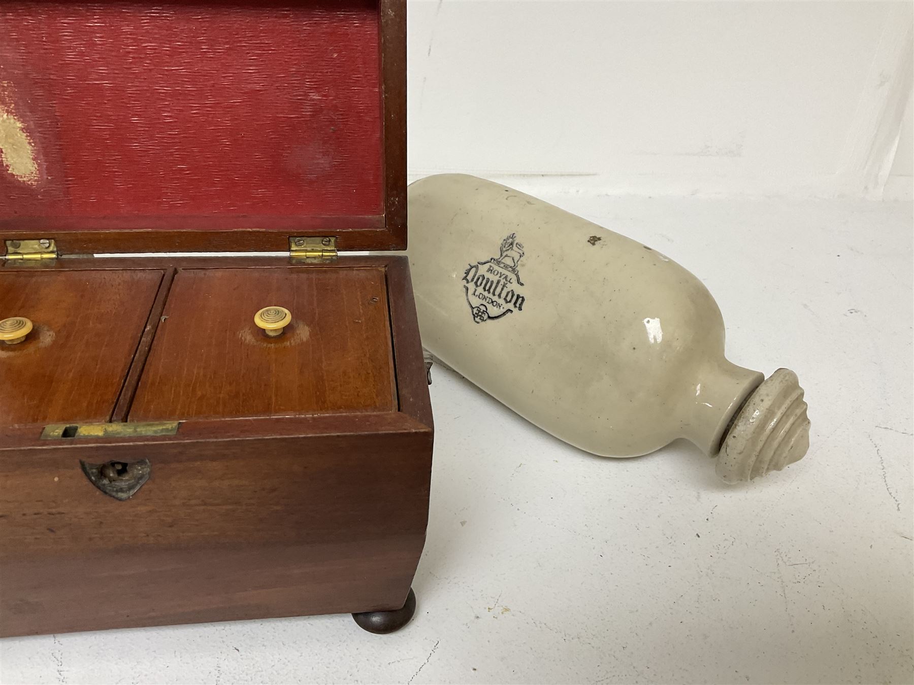 sarcophagus shaped tea caddy with bun feet, together with two stone hot water bottles, caddy H17cm 