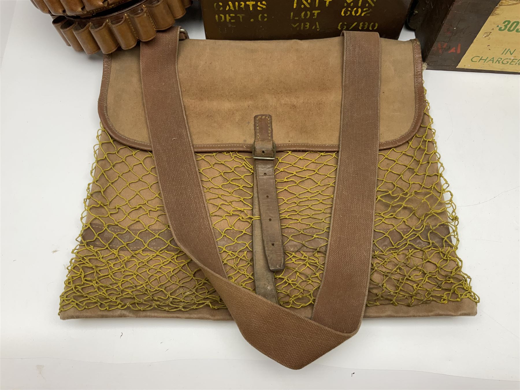 Miscellaneous shooting accessories - W.J. Bowman & Sons clay pigeon launcher; two leather cartridge belts; three cartridge bags; two canvas/leather game bags; and two metal/wooden cartridge boxes