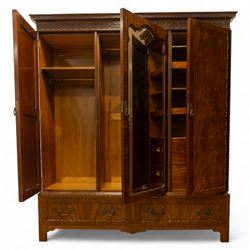 Waring and Gillow - Edwardian style figured mahogany three-section figured wardrobe, moulded and blind fretwork cornice, above three panelled doors, central door with bevelled mirror plate flanked by book-matched flame mahogany panels with moulded borders, above two long drawers with swan-neck handles, raised on bracket feet 