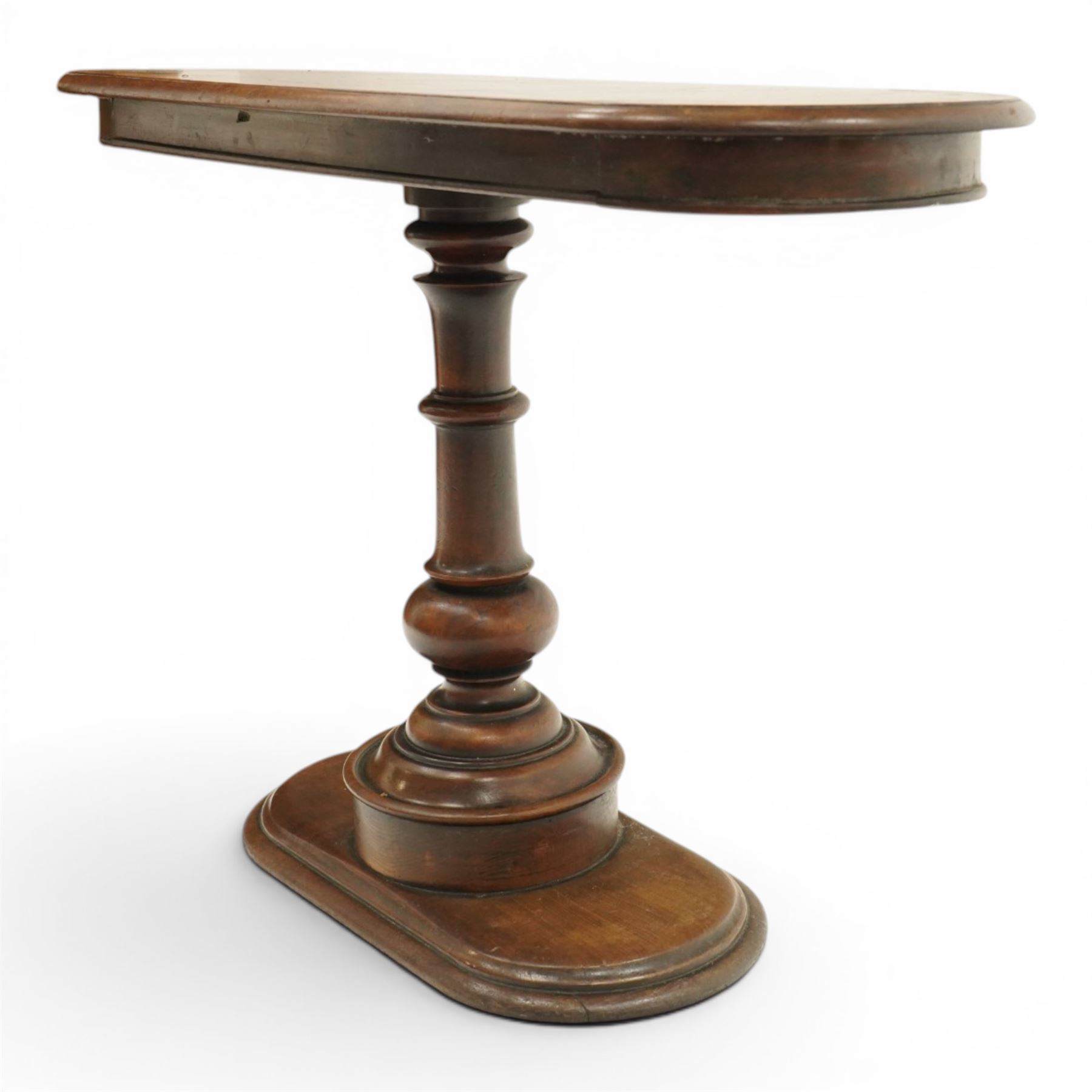 Georgian mahogany console table, the top of oval form, above a turn vasiform column, above an oval plinth base 