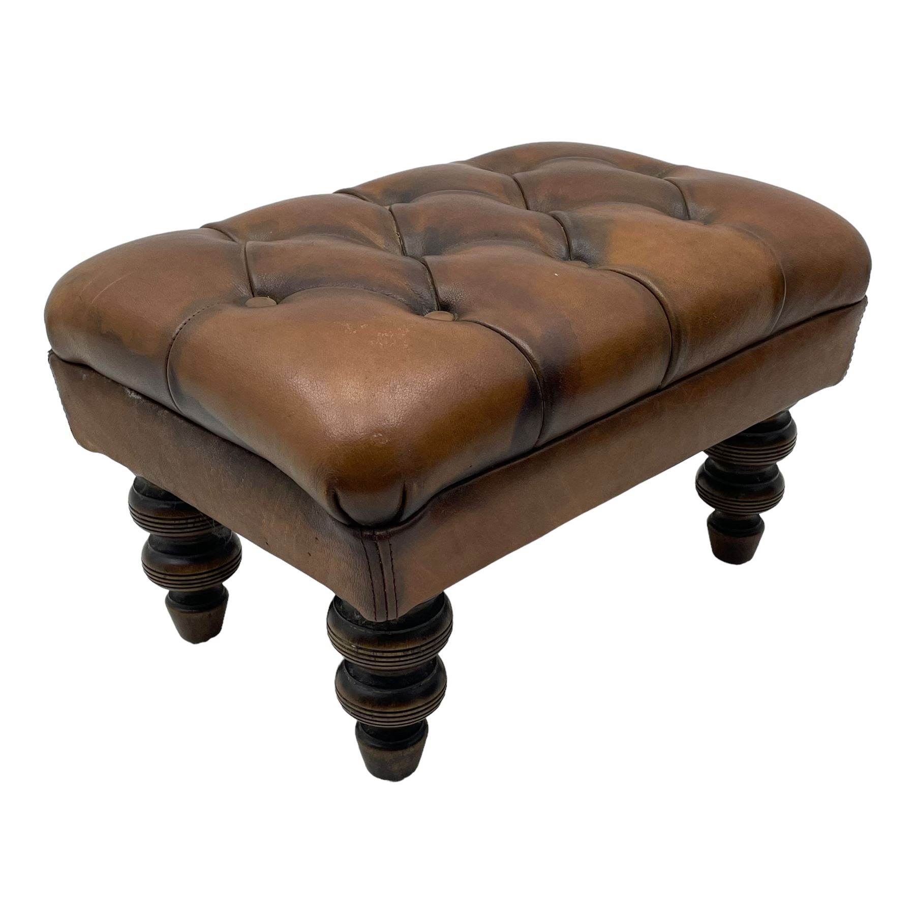 Laura Ashley - hardwood-framed armchair, traditional shape with arched cresting rail over rolled arms, upholstered in buttoned brown leather with studded work, on turned front feet (W76cm, W95cm, D84cm); together with matching rectangular footstool (53cm x 34cm, H29cm)