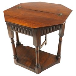 Gothic Revival oak fold-over console table, of octagonal form when unfolded, carved frieze with full length undertier 