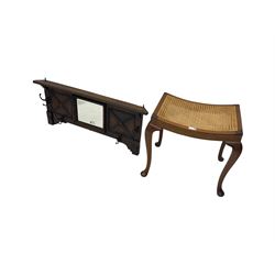 Early 20th century oak coat rack, bevelled centre mirror with flanked panels with beaded design; and mahogany stool, cane work seat raised on cabriole supports with pad feet (2)