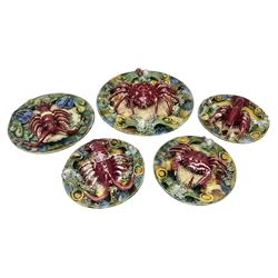 Five 20th Century Portuguese Palissy style Majolica wall plates, all depicting crustaceans to the centre modelled in relief surrounded by encrustations and shells, both with impress marks beneath, largest D29cm