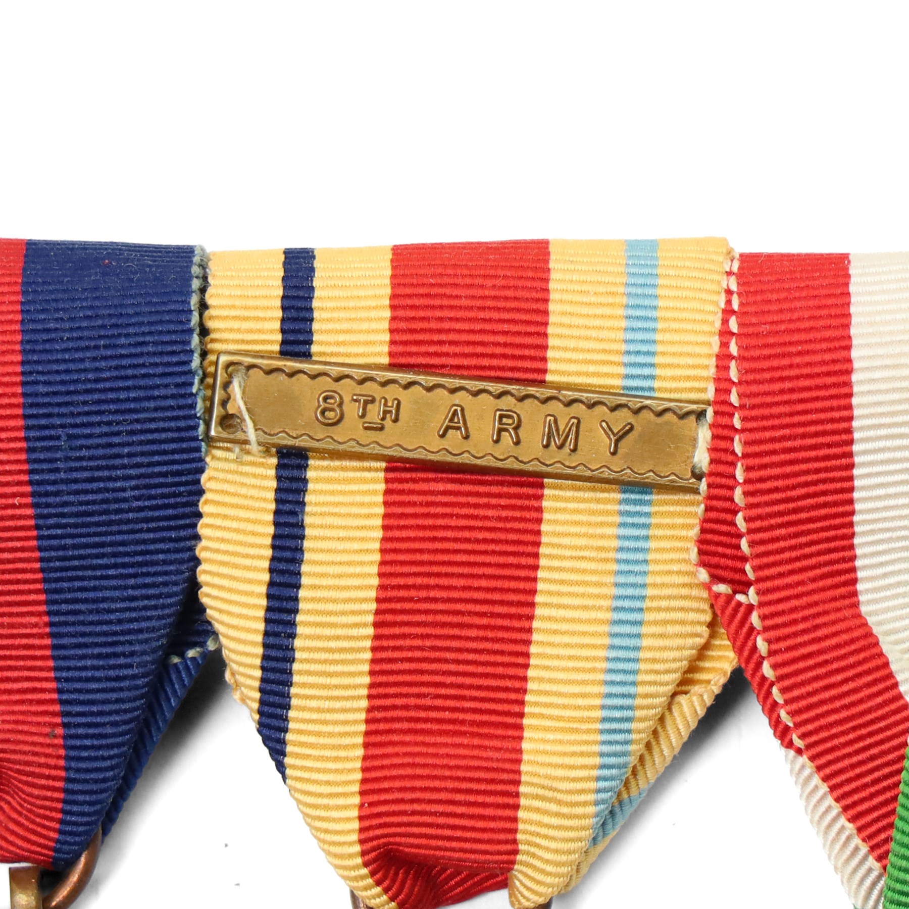 Five medals, possibly a family group comprising WWI War Medal to 9220 Pte H L Skillicorn, Machine Gun Corps and four WWII medals comprising War Medal, Africa Star with 8th Army bar, 1939-1945 Star and Italy Star, a German cap badge and one other German badge