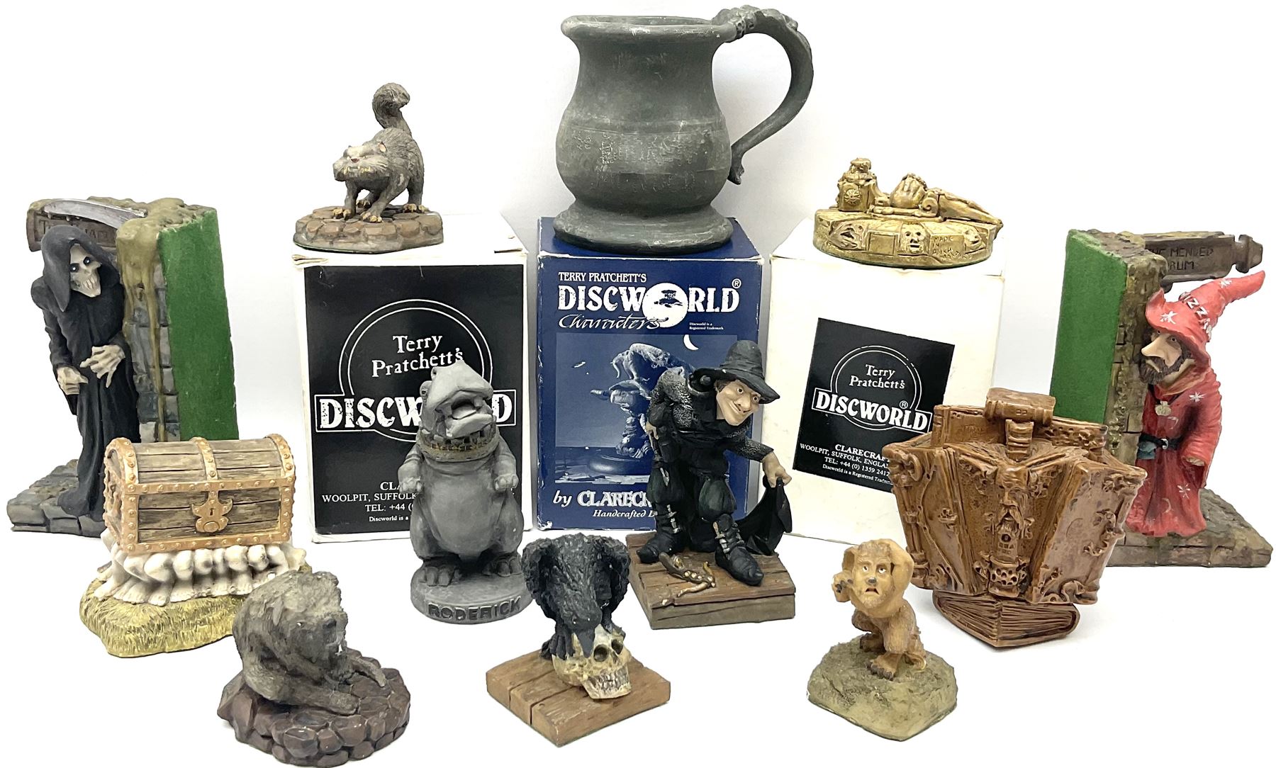 Terry Pratchett Discworld figures, comprising Roderick the hippo, DWE2, a 1995 event piece, Rincewind bookend, DW11, Death bookend, DW12, Librarians wizard knob, boxed, DW55, the luggage, boxed, DW04, tankard from the mended drum, DW21, Teppic the assassin, DW32, Greebo, DW45, Herne the hunted, DW64, Gaspode,  DW31, Quoth on skull, DW49 and Dibbler's compass DW16. 