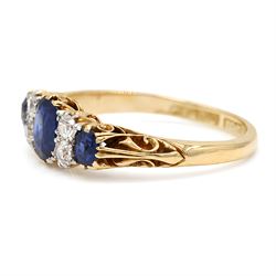 Early 20th century gold sapphire and diamond ring, three vari-cut sapphires, spaced by four old cut diamonds, with scroll design shoulders, stamped 18ct, total sapphire weight approx 1.45 carat, total diamond weight approx 0.30 carat