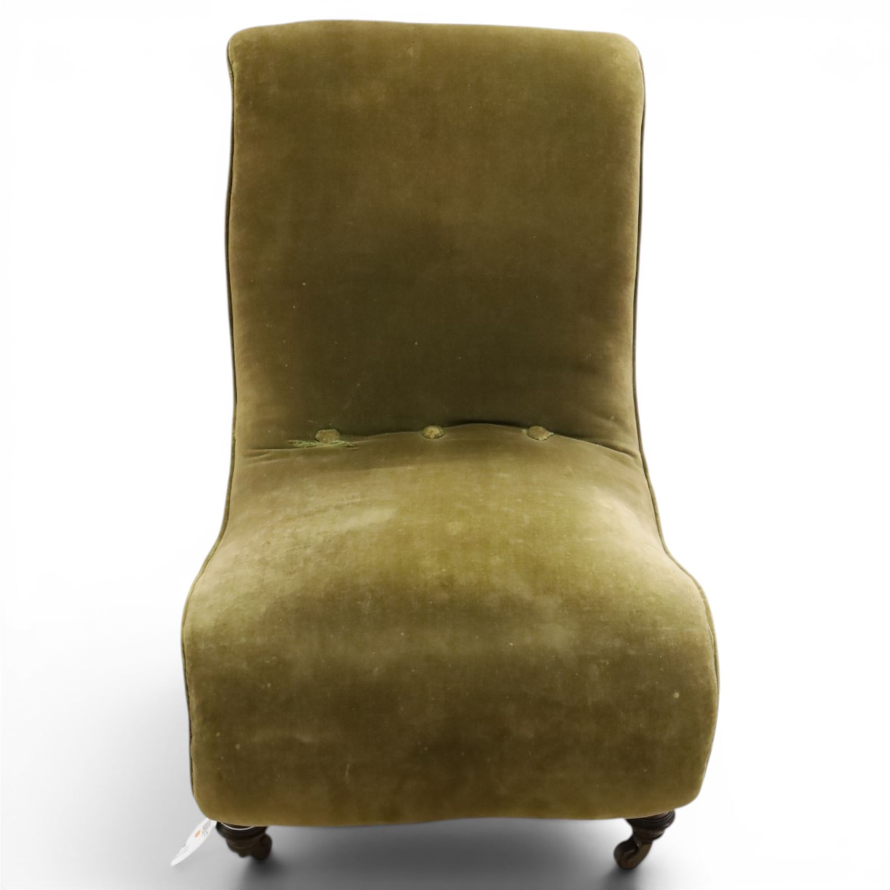 Victorian mahogany framed slipper chair, of reclined shape with rolled back over sprung seat, raised on turned feet with ceramic castors