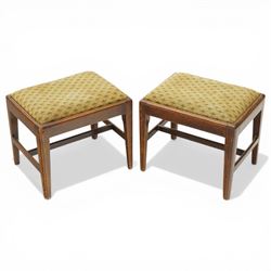 Pair of George III mahogany framed coaching stools, the drop-in seats upholstered in green...