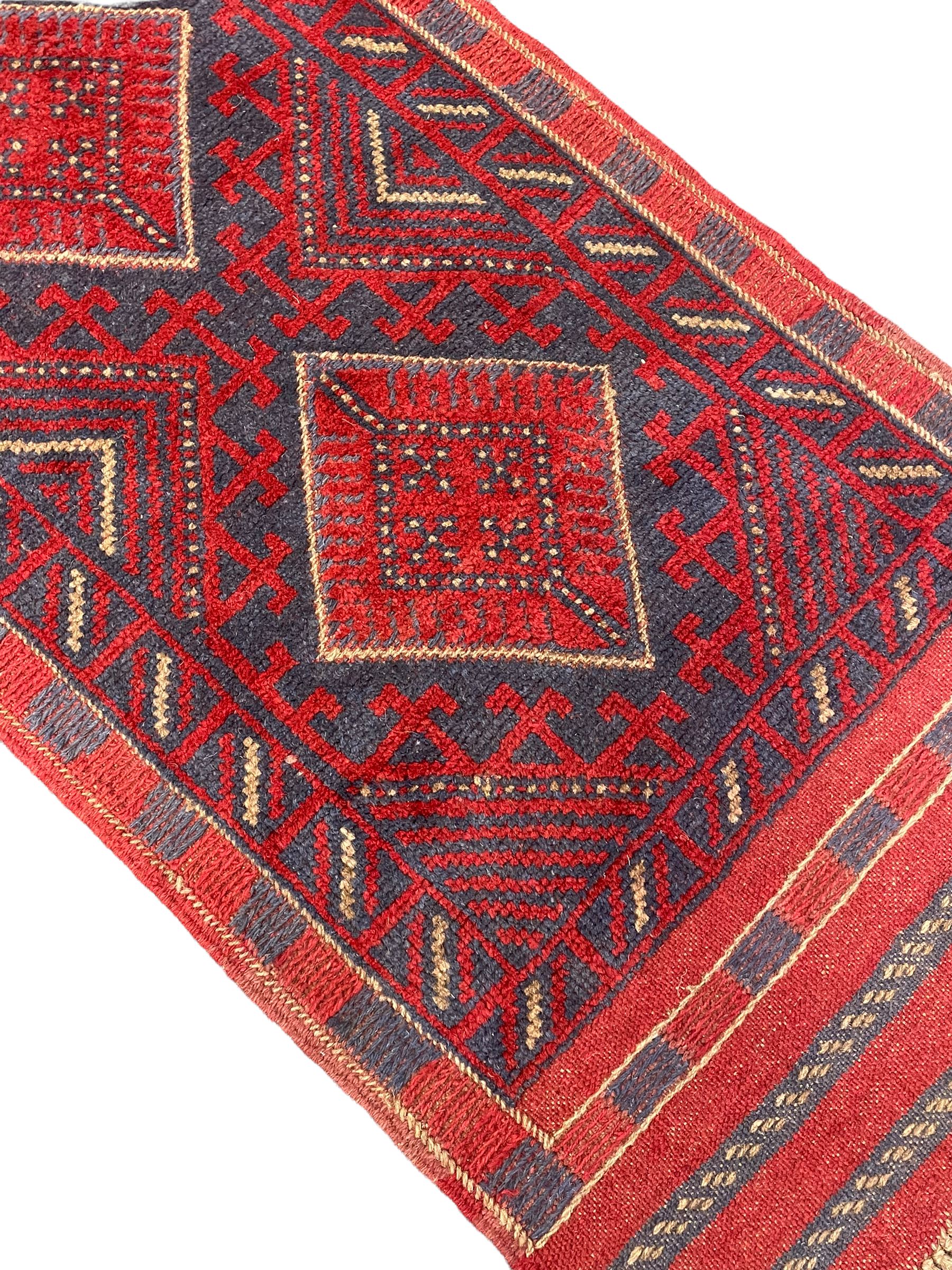Meshwani red and blue ground runner, four lozenge medallions, overall geometric design 