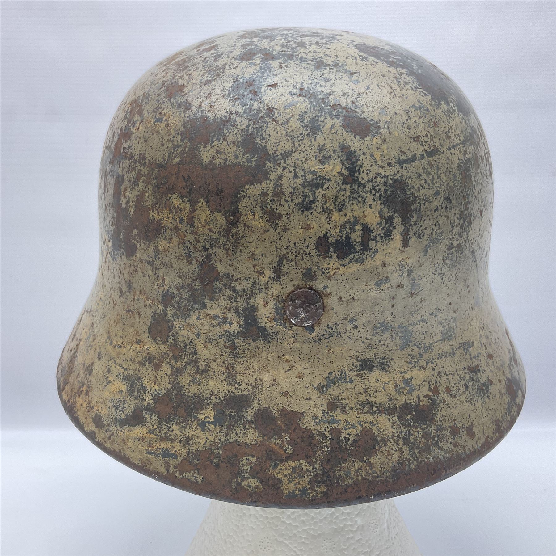WW2 German Infantry M40 steel helmet with tropical finish and traces of single decal; with chin strap and leather liner marked 57 twice in red; back apron stamped 11 38