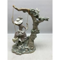 Lladro figure, Swinging, modelled as a woman sat on a swing attached to a tree branch, sculpted by Salvador Debon, no 1297, year issued 1974, year retired 1989, together with Collectors Society items and limited edition eggs, etc, largest example H41cm 
