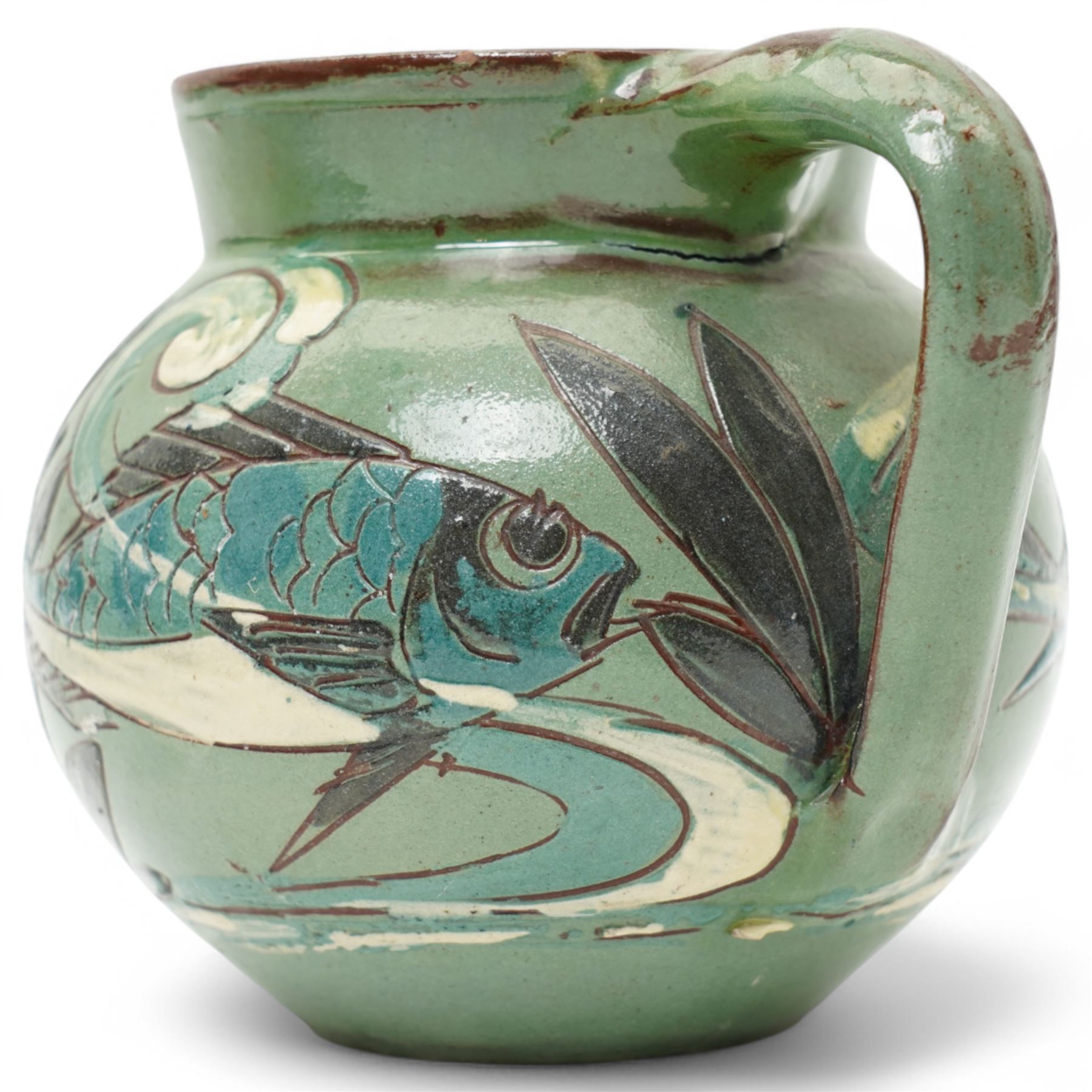 Late 19th century C H Brannam pottery Barum ware sgraffito jug, in green and brown glaze, decorated with fish swimming amongst reeds, signed and dated 1892 to base, H10cm 