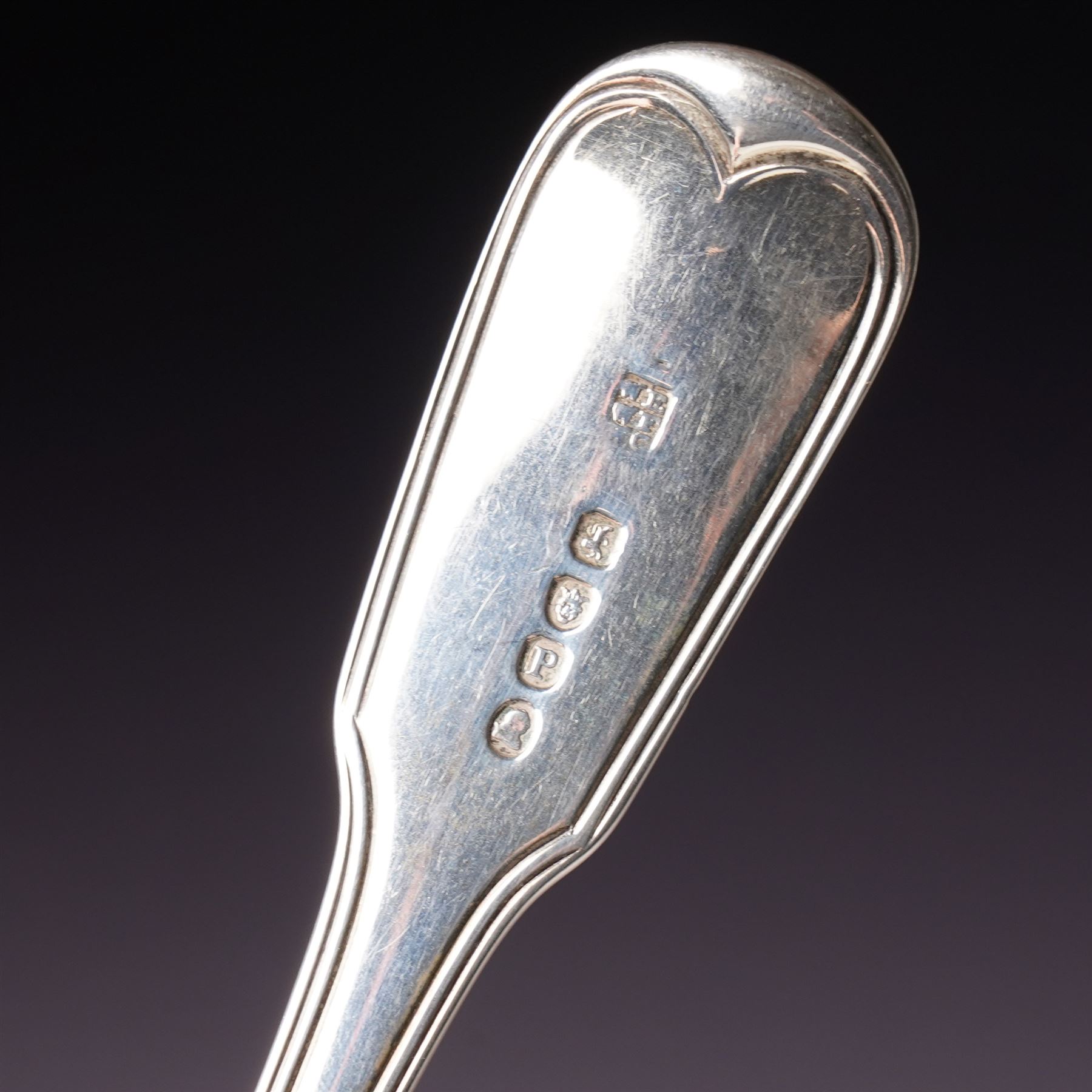 George III silver 'berry' spoon with later embossed and gilded bowl and engraved stem London 1786, sifting spoon similarly gilded and decorated and a George III silver fiddle and thread pattern table spoon London 1810 (3)