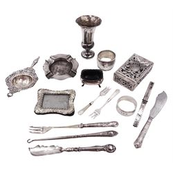 Group of silver, including tea strainer, with floral repousse decoration, hallmarked Henry Matthews, Birmingham 1903, matchbox cover, with pierced foliate decoration and spring action opening, stamped Mexico 925, silver mounted photograph frame, napkin rings, silver handled items and a weighted vase, all stamped or hallmarked 